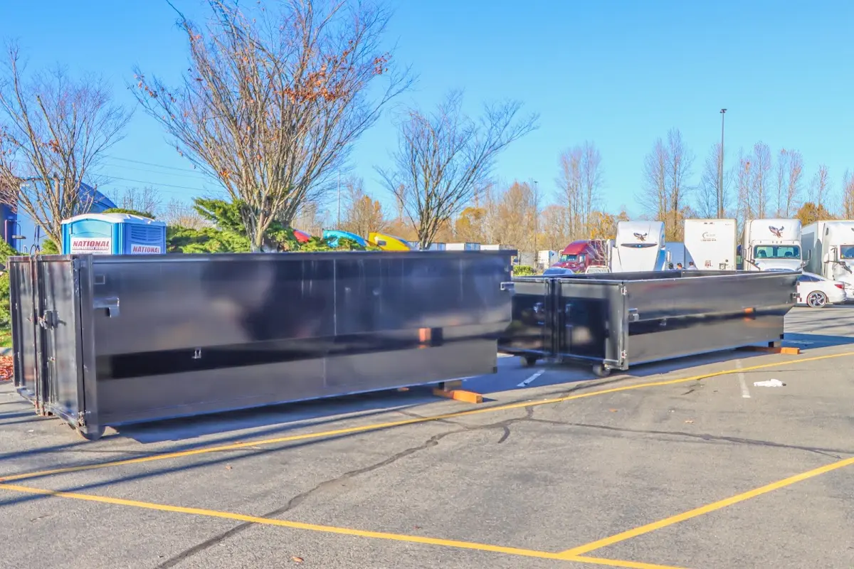 Professional dumpster rental service with roll-off container on residential driveway in Poland